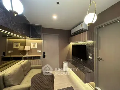 Modern living room with stylish decor and wall-mounted TV in a cozy apartment.