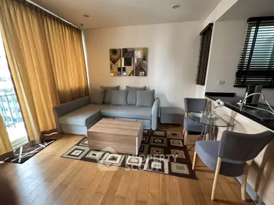 Modern living room with cozy sofa, stylish decor, and wooden flooring in a contemporary apartment.