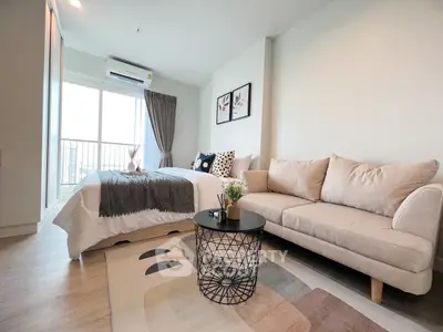 Modern studio apartment with cozy living area and stylish decor