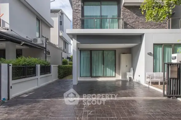 Modern townhouse exterior with sleek design and spacious driveway