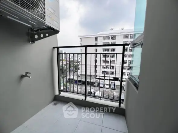 Modern balcony with city view and air conditioning unit, perfect for urban living.