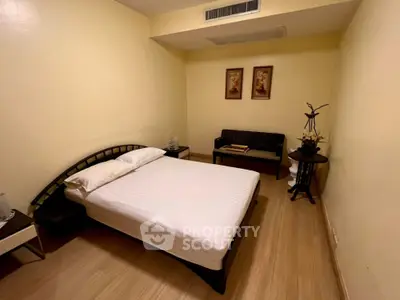 Cozy bedroom with modern decor and wooden flooring, perfect for relaxation and comfort.