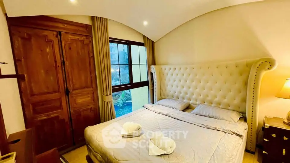 Luxurious bedroom with elegant decor and large window view
