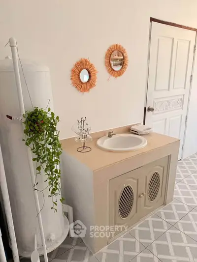 Charming bathroom with stylish vanity and decorative mirrors, perfect for a cozy home ambiance.