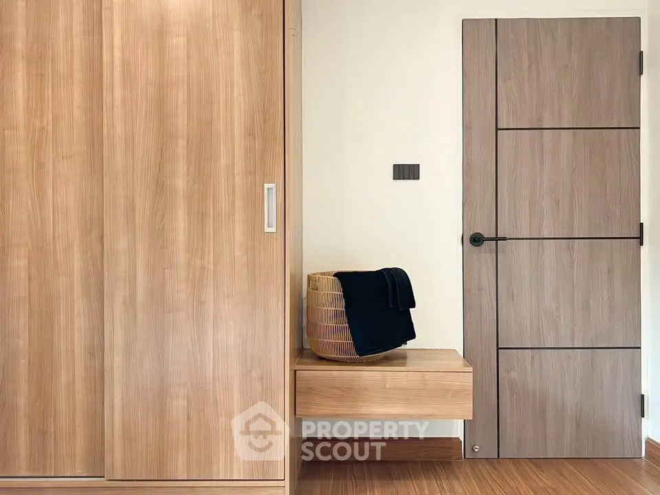Modern interior with wooden wardrobe and stylish door in a cozy room.