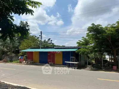 Colorful roadside building with vibrant panels under a clear blue sky.