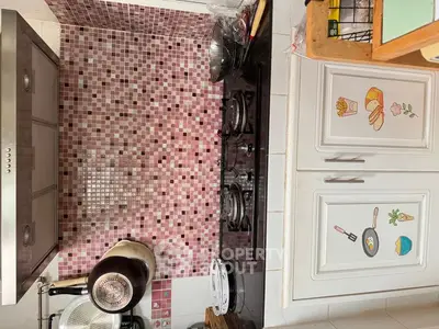 Charming kitchen with mosaic backsplash and gas stove, perfect for culinary enthusiasts.