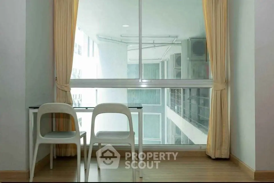 Bright study area with large window and modern furniture in urban apartment