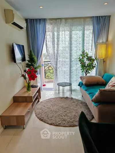 Charming living room with balcony view, cozy seating, and elegant decor in a modern apartment.