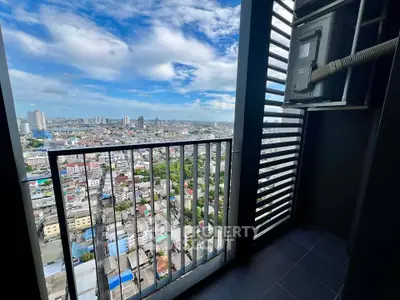Stunning high-rise balcony view overlooking cityscape with clear blue skies, perfect for urban living.