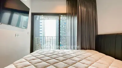 Modern bedroom with balcony view in high-rise apartment