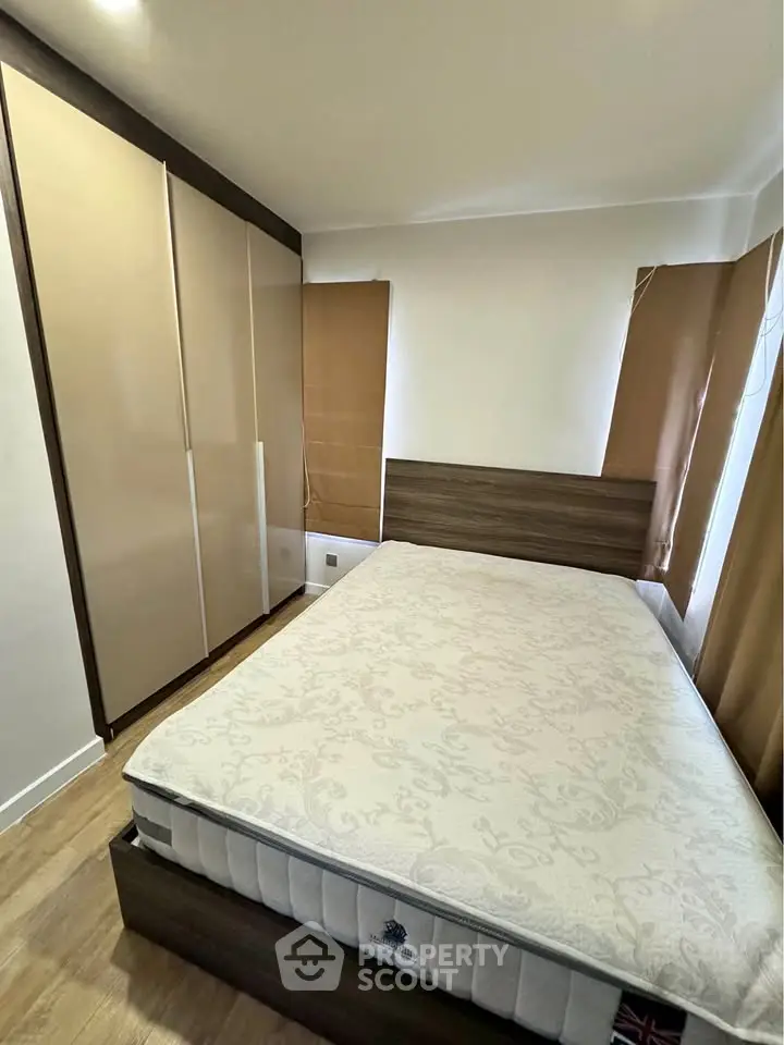 Cozy bedroom with modern wardrobe and comfortable bed in a stylish apartment.