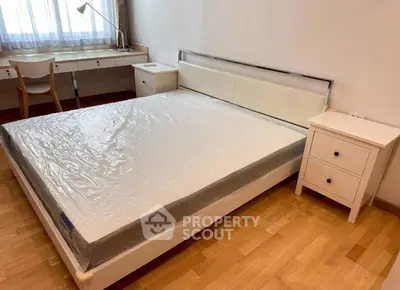 Spacious bedroom with modern furniture and natural light