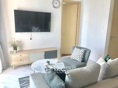 Modern living room with wall-mounted TV and stylish furniture