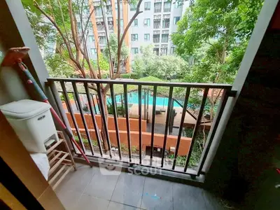 Charming balcony with pool view in modern apartment complex