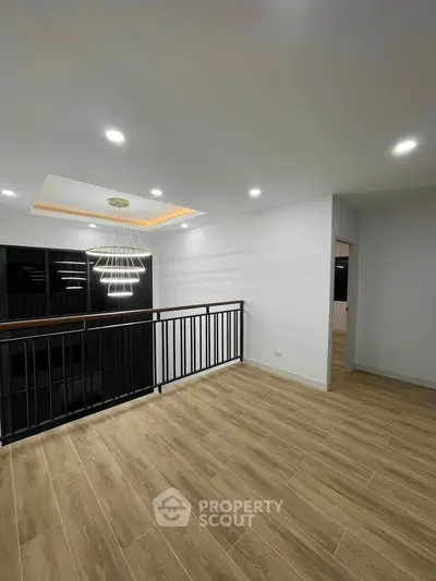 Modern interior with elegant lighting and wooden flooring, perfect for stylish living.