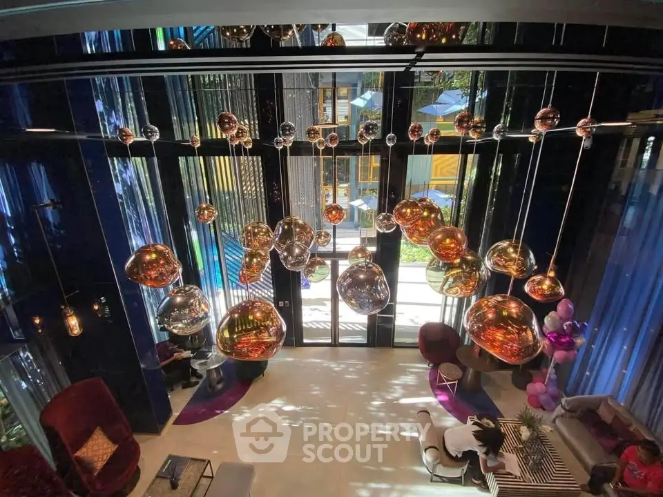 Luxurious modern living room with stunning chandelier and floor-to-ceiling windows