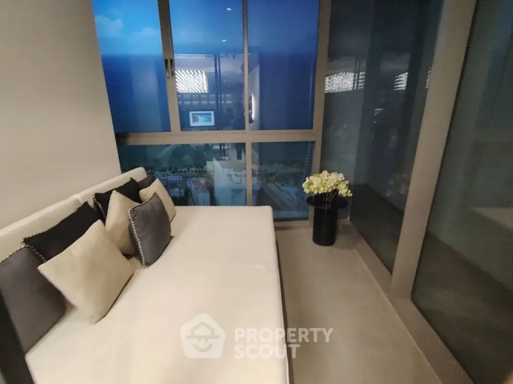 Modern balcony with cozy seating and stunning city view