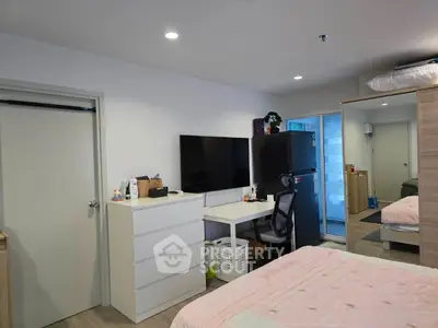Modern bedroom with sleek furniture and wall-mounted TV, ideal for urban living.