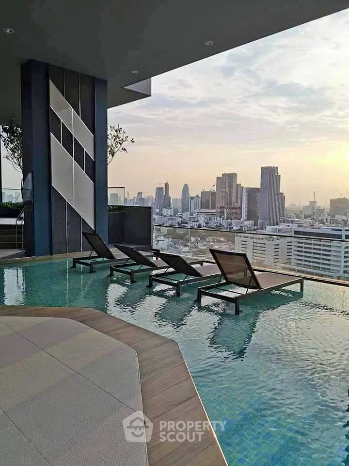 Luxurious rooftop pool with stunning city skyline view, perfect for relaxation and leisure in urban living.