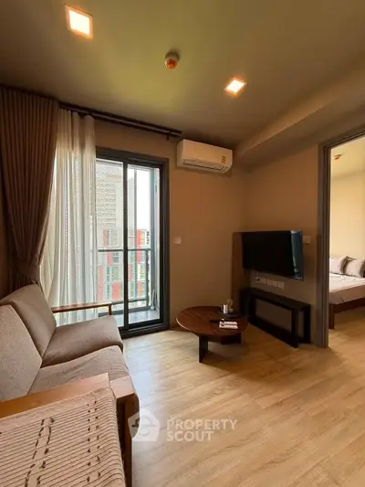 Modern living room with balcony access and stylish furniture in a cozy apartment.