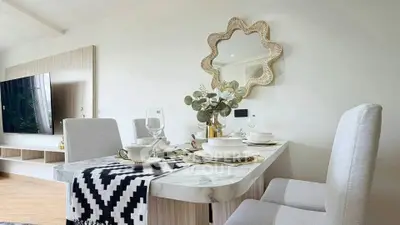 Elegant dining area with modern decor and stylish mirror in a cozy living space.