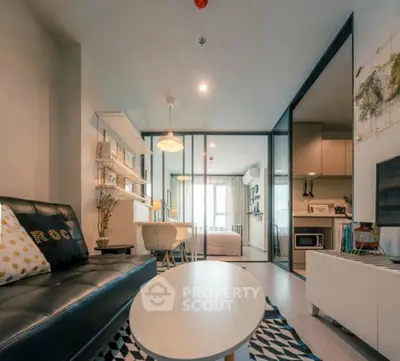 Modern living room with sleek design and open layout, featuring stylish furniture and natural light.