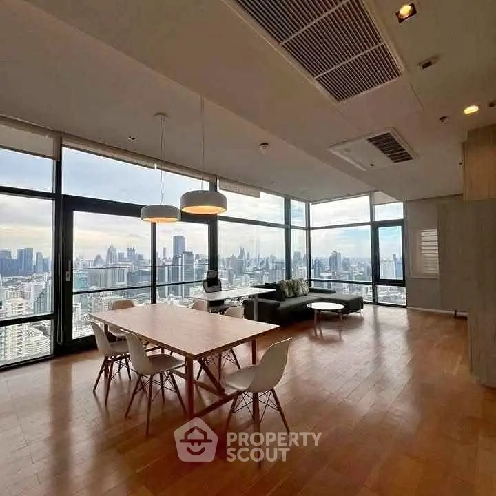 Spacious modern living room with panoramic city views and elegant dining area.