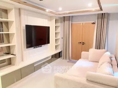 Modern living room with sleek TV setup and cozy sofa, perfect for relaxation and entertainment.