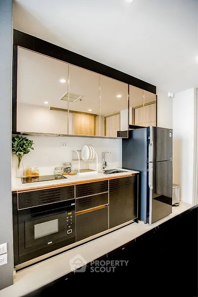 Modern kitchen with sleek black appliances and open layout design