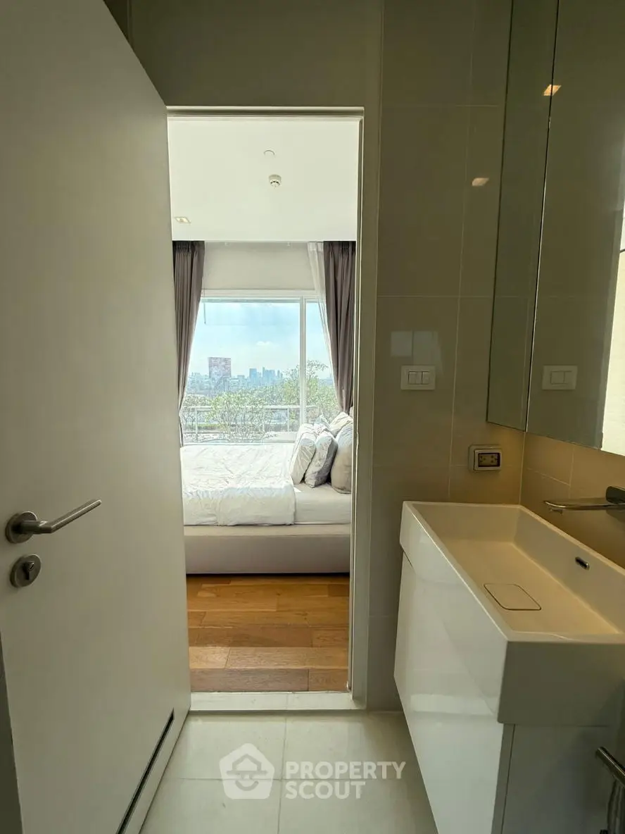 Modern living room with stylish decor and large window view.