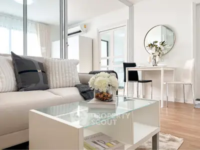 Modern living room with elegant decor and natural light, featuring a cozy sofa and stylish glass coffee table.