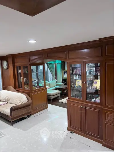 Spacious living room with elegant wooden cabinetry and cozy seating area