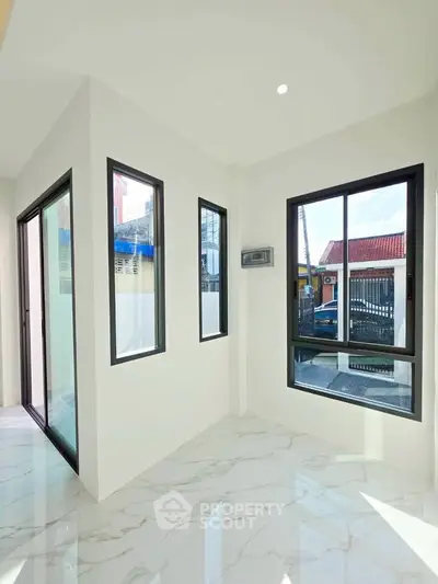 Bright corner unit with large windows and marble flooring, offering a modern and airy atmosphere.