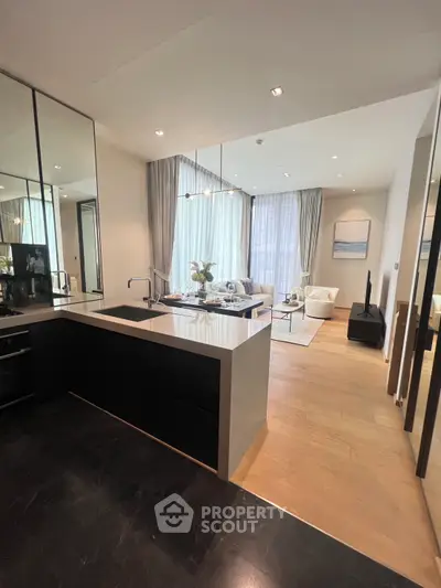 Modern open layout kitchen and living room with sleek design and natural light