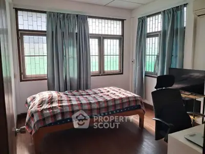 Bright bedroom with large windows and modern furnishings