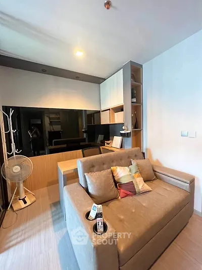 Modern living room with stylish sofa and built-in shelving, perfect for cozy urban living.