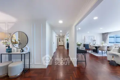 Spacious open-plan living and dining area with elegant hardwood flooring and modern decor.