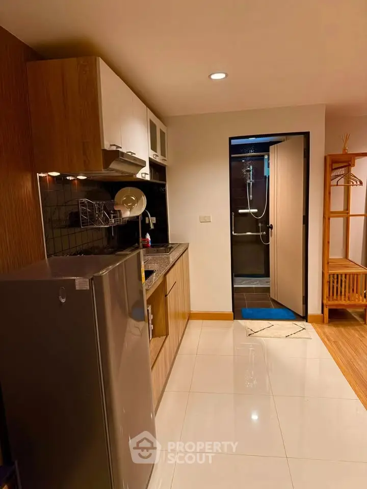 Modern compact kitchen with sleek appliances and stylish cabinetry