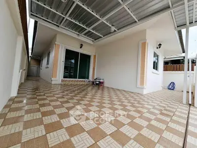 Spacious covered patio with tiled flooring and modern design