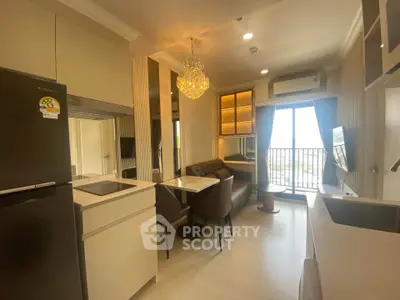 Modern open-layout kitchen and living area with chandelier and balcony view