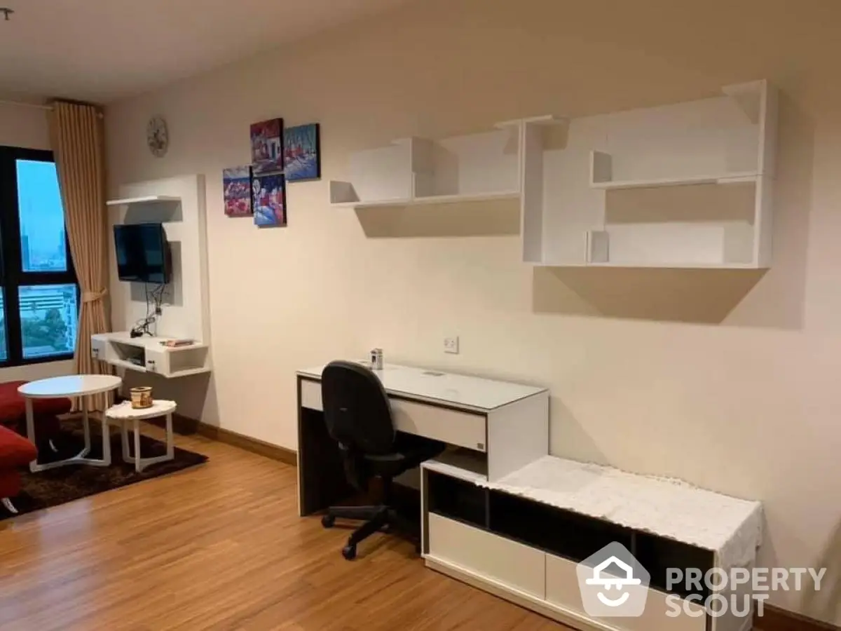 Modern study area with desk, chair, and wall shelves in cozy apartment.