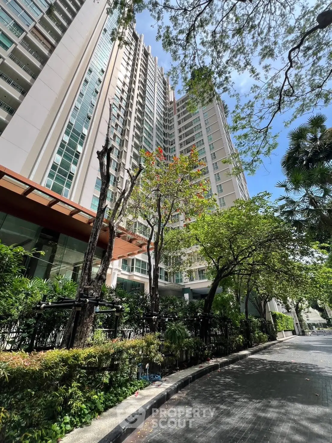 Stunning high-rise residential building with lush greenery and modern architecture.