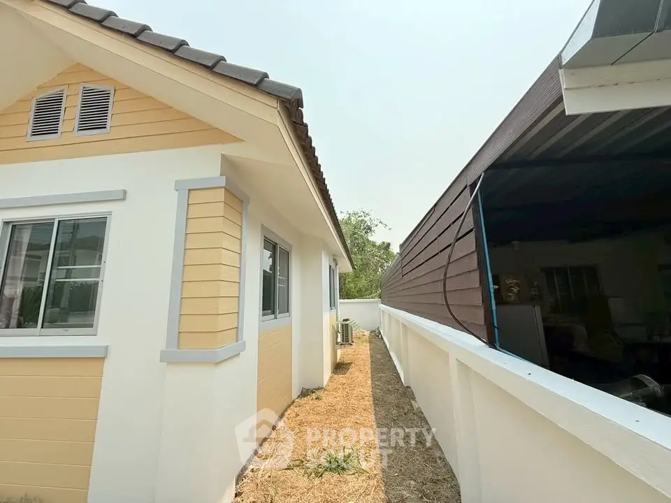 Charming single-story home with modern exterior and spacious side yard