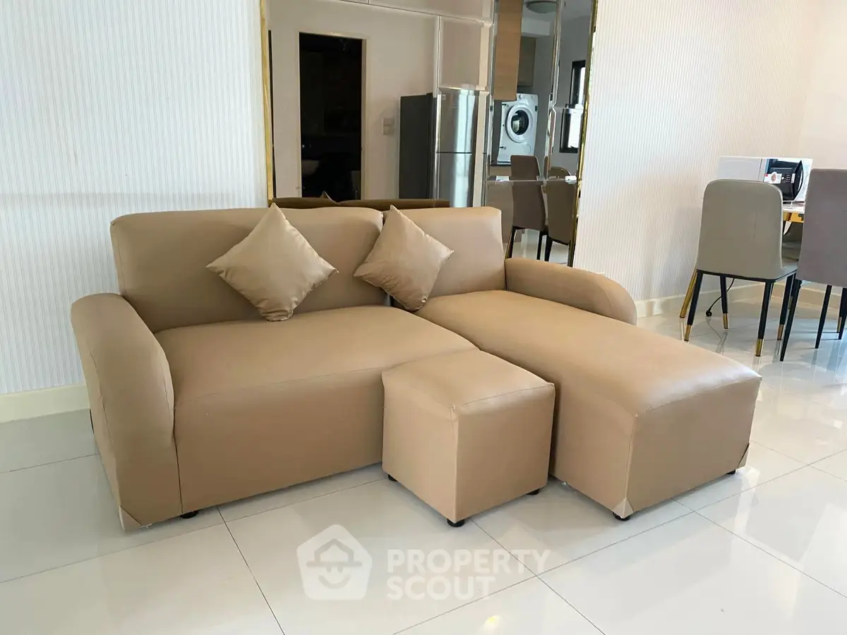 Modern living room with stylish beige sofa and sleek dining area