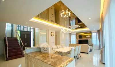 Luxurious open-plan living room with elegant dining area and modern decor