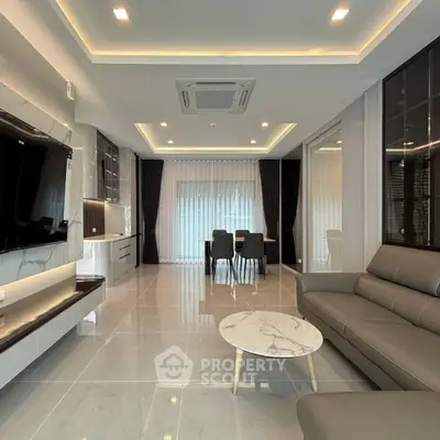 Modern living room with sleek furniture and open dining area, featuring elegant lighting and marble accents.