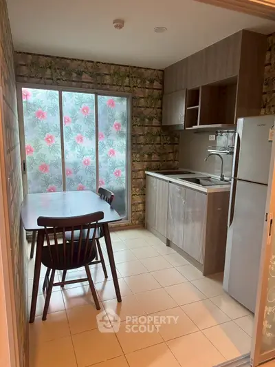 Charming kitchen with floral window view and modern appliances in cozy apartment.