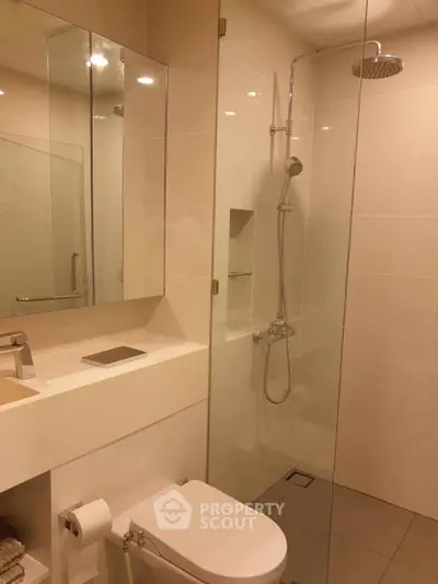 Modern bathroom with glass shower and sleek fixtures