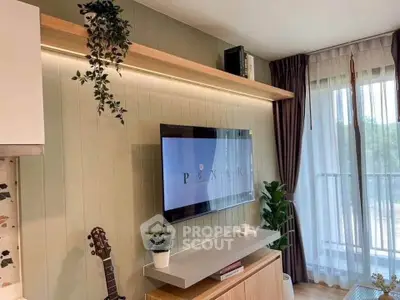 Modern living room with wall-mounted TV, stylish decor, and large window with balcony view.